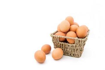 Fresh eggs in basket on white background