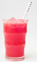 Tropical juices in glasses on background