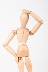 Plain wood mannequin stand upright isolated on white holding hea