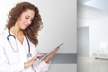 young and beautiful woman holding a portable computer