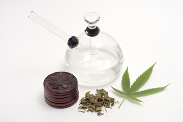 Dried Cannabis and glass bong , isolated on white