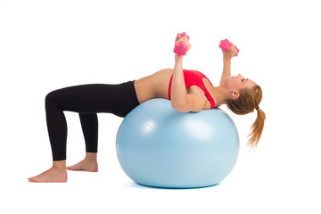 Female Exercise On Fitness Ball With Hand Weights