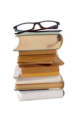 Stack of books and glasses isolated on white background.