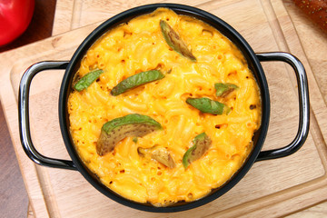 Pot of Macaroni and Cheese with Avocado Slices on Table