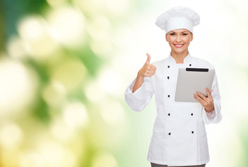 smiling female chef with tablet pc computer