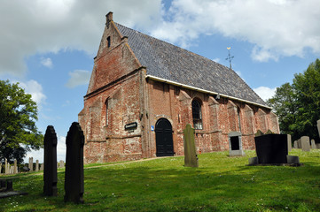 Fototapeta na wymiar A small old protestant church gothic style in Dutch Friesland