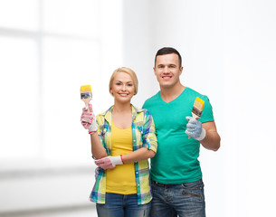 smiling couple with paintbrush