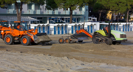 Bulldozers at Work on a Sandy Beach