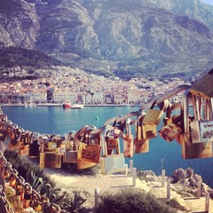 Love padlocks with city of Makarska at background