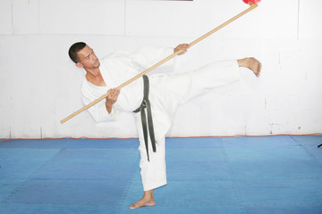 Man in shotokan karate with a bo in his hands © dacasdo