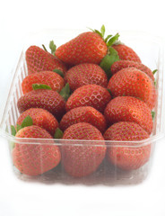 Ripe strawberries in plastic container  isolated closeup