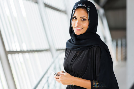 young arabian woman holding smart phone