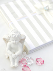 A little miniature statue of a white angel with wings on a white