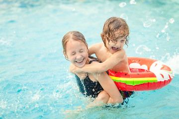 two little kids playing in the pool