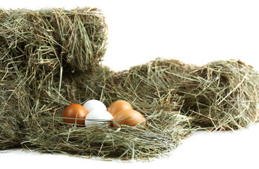 Eggs on hay, isolated on white