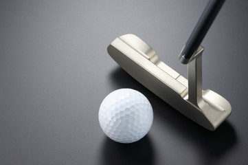 Practicing putter.