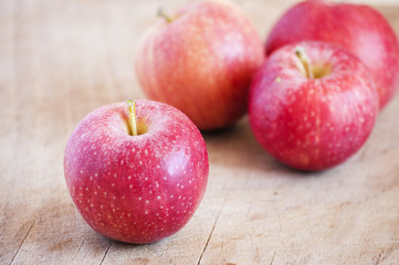 red apples on wooden table, selective focus
