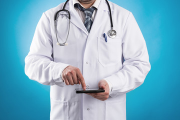 Male doctor using tablet computer for research