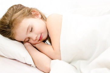 Fototapeta na wymiar Little girl sleeping in her bed