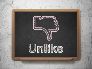 Social network concept: Thumb Down and Unlike on chalkboard