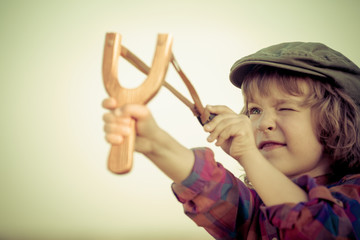 Kid holding slingshot