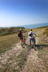 Obraz premium Couple walking in countrypath with bikes