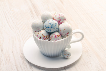 Chocolate Easter eggs in white cup