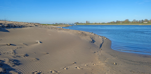 Ship sailing on a river under a clear sky