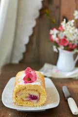 Swiss roll with cream and raspberries