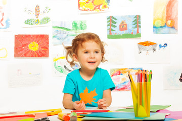 Happy girl with color paper