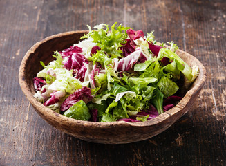 Fresh salad leaves mix in wooden bowl