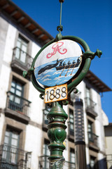 Old street sign with fishers fishing wales in Lekeitio