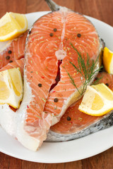 fresh salmon with lemon on plate