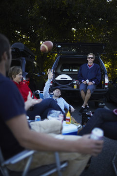 A group of friends at a barbeque or tailgate party at an event. 
