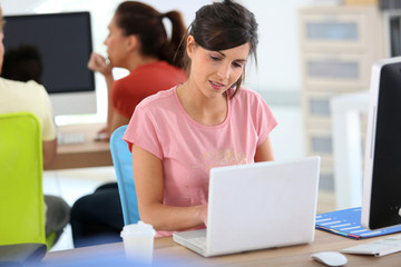 Young woman in business training with laptop
