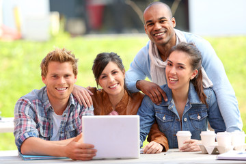 Group of students working outside on laptop