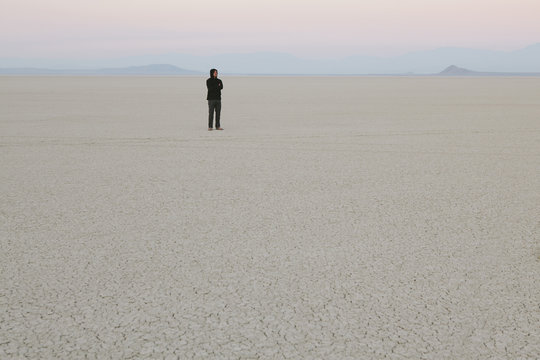Man standing in vast, desert landscape