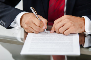 Businessman writing on a form