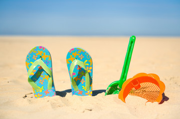 Toys and flip flops at the beach