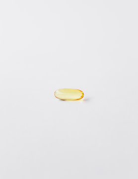 Fish oil providing Omega-3, in a softgel supplement capsule, a health supplement and fatty acid often recommended for health. 