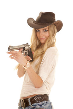 woman light shirt hat gun holding up looking