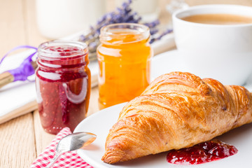 Croissants with raspberry and orange jam.