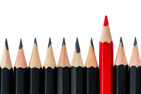 Row of black pencils with one red pencil in middle