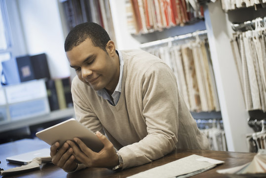 Man working in design shop with tablet