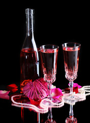 Composition with pink  wine in glasses, bottle  and  roses