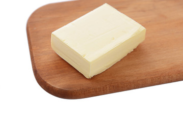 Tasty butter on wooden cutting board isolated on white