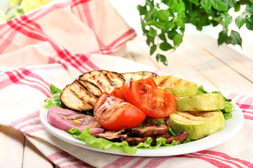 Delicious grilled vegetables on plate on table close-up