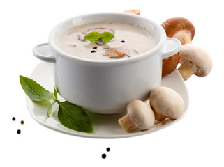 Mushroom soup in white bowl, on plate, isolated on white