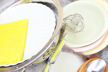 Utensils soaking in kitchen sink