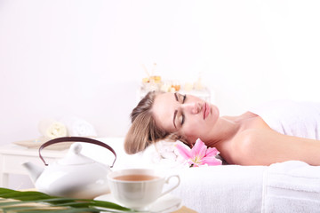 Beautiful young woman having relax in spa salon